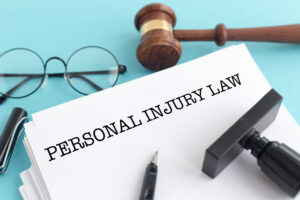 personal injury law document with stamp, glasses, and gavel
