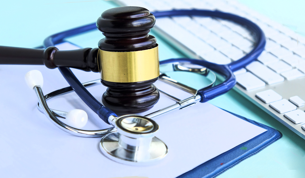 How to Decide If You Should Settle or Take Your Personal Injury Case to Trial - Gavel and stethoscope. medical jurisprudence. legal definition of medical malpractice. attorney. common errors doctors, nurses and hospitals make.