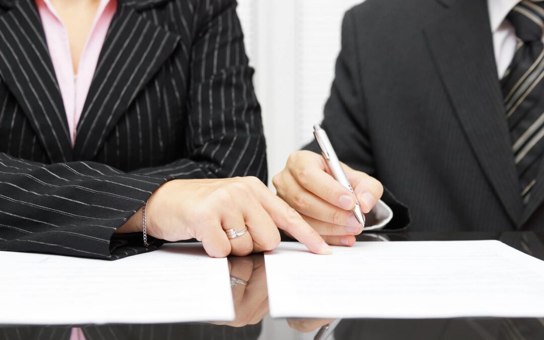 wrongful termination lawyer with an attorney and client signing a contract